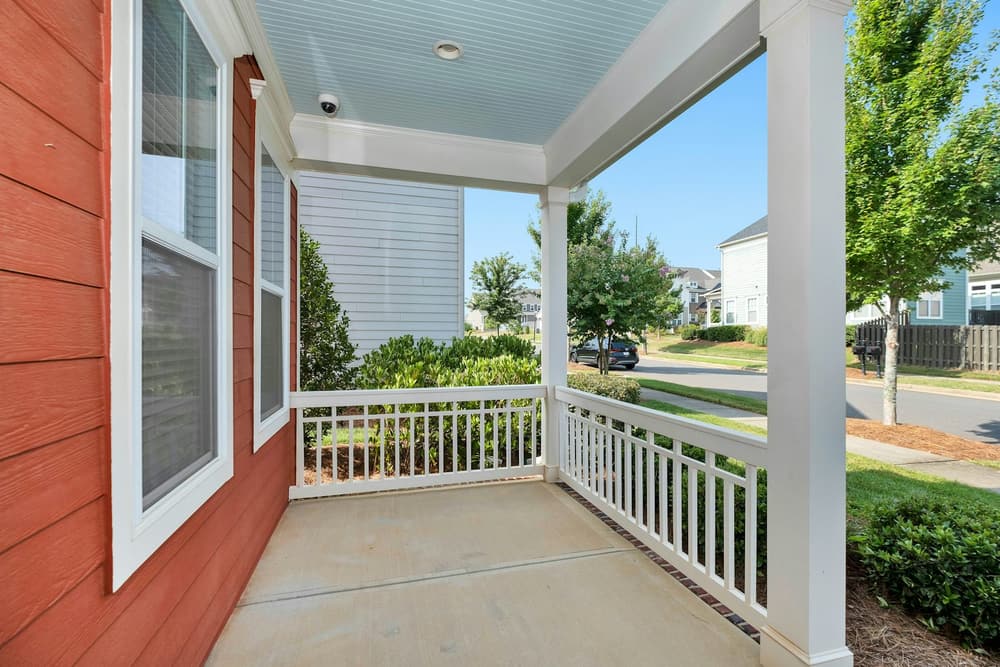 A front porch overlooking a residential street